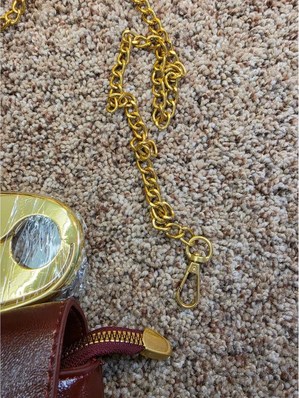 Elegant Burgundy Faux Leather Clutch Bag with Gold Chain and Safety Pin Detail